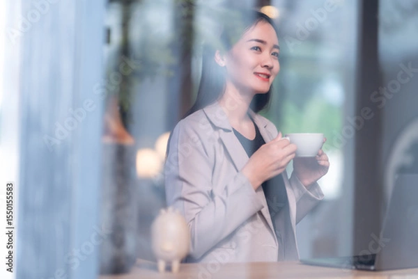 Obraz Portrait of beautiful happy Smiling  of hands Holding cup mug of Hot coffee latte wits business female casual working with laptop computer in coffee shop like the background,communication concept