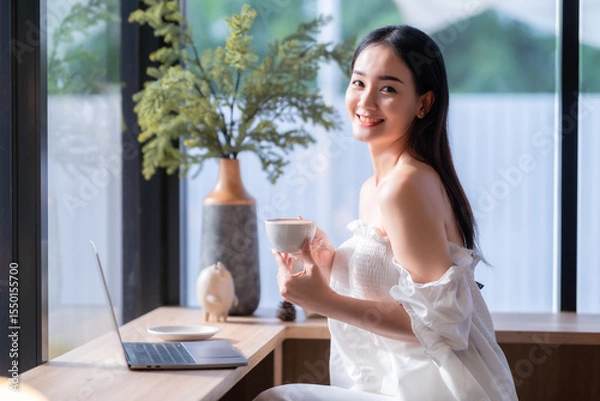 Obraz Portrait of beautiful happy Smiling  of hands Holding cup mug of Hot coffee latte wits business female casual working with laptop computer in coffee shop like the background,communication concept