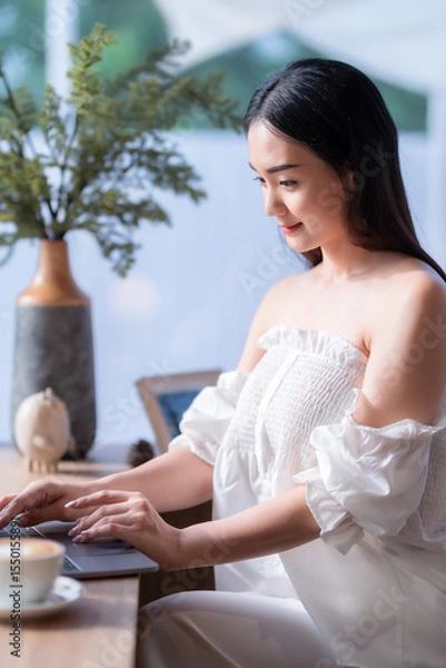 Obraz Asian freelance people business female talking making using casual working with laptop computer and coffee at home in the living room indoors artificial rose bouquet of red and pink roses rose vase