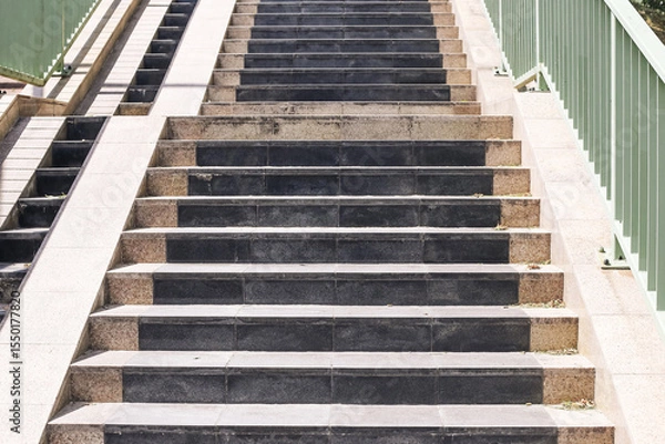 Fototapeta Modern concrete staircase detail. Outdoor urban steps with handrails. Clean architectural lines and symmetry. Daylight construction design. Contemporary city infrastructure element.