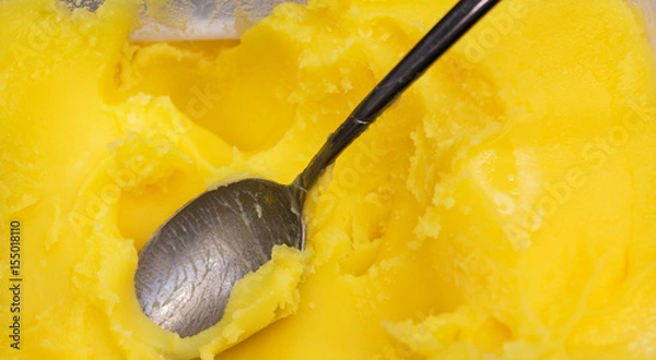 Fototapeta Closeup of ghee butter - famous cooking ingredient, element of bulletproof diet.