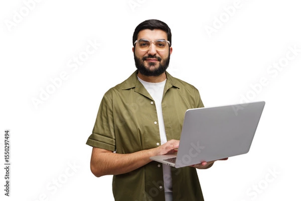 Fototapeta Man in a green shirt smiles while holding an open laptop, fingers poised over the keys, ready to work on a sunny afternoon in the office