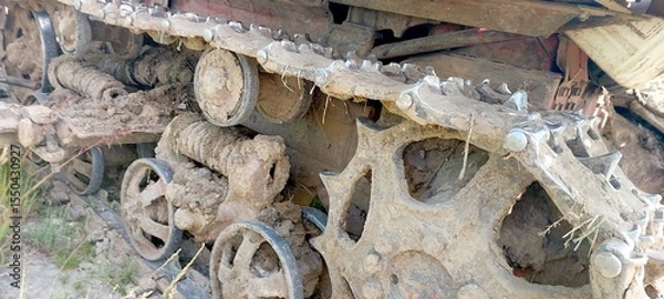 Fototapeta DT Tracked Tractor Navigating Through Muddy Terrain During Springtime Agricultural Activities