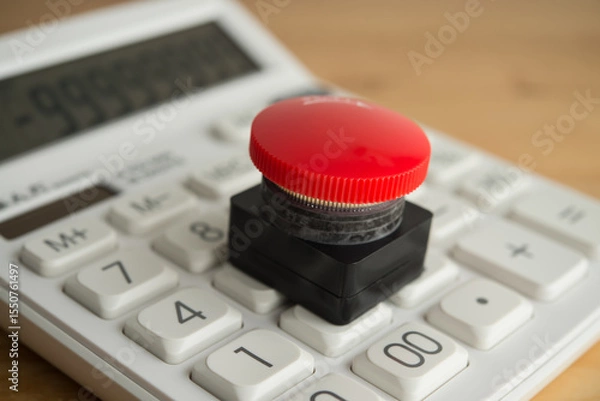 Fototapeta Closeup red emergency button on white calculator background. Financial crisis, bankrupt, loss, refinancing, debt restructuring, stop payment, risk management and so on concept.