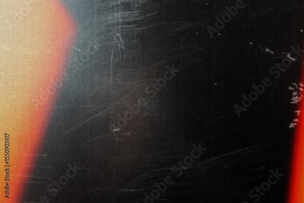 Fototapeta grungy black texture with vintage scratches and orange light leak for edgy web design, print media background, and creative branding graphics