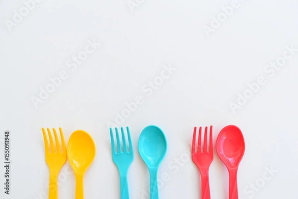 Fototapeta colorful spoon and fork isolated on white background, plastic cutlery for picnic