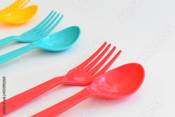 Fototapeta colorful spoon and fork isolated on white background, plastic cutlery for picnic
