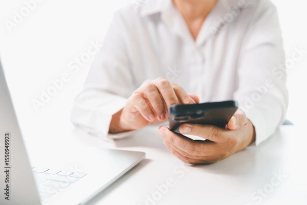 Obraz Close-up businesswoman using smart mobile phone at office table, female student is home studying online e-learning, searching for information on internet, engaging with social networks.