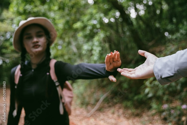 Obraz Two friends helping with teamwork trying to reach top of mountains during wonderful summer sunset. Teamwork couple hiking help each other trust assistance. Team of climbers two friends hiker.