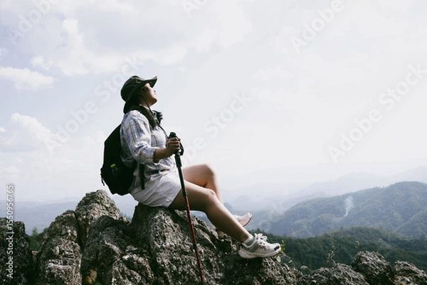 Obraz Woman hiker on top of mountain. Hiker with arms up on top of mountain successful young woman enjoying triumph. traveler exploring world. Hikers with backpacks relaxing. Sport and success concept.