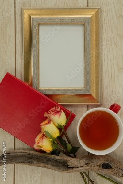 Obraz Photo frame, lemon tea and flowers on wooden table