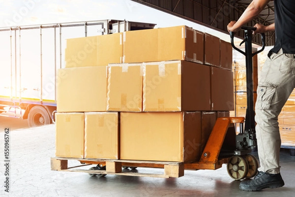 Fototapeta Workers Loading Package Boxes into The Truck. Forklift Pallet Jack. Package Boxes. Shipping Container. Distribution Warehouse, Supply Chain, Shipment, Freight Truck Logistics Transportation.	
