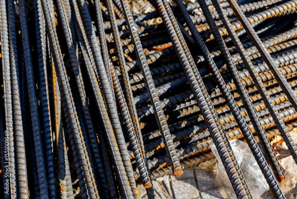 Fototapeta Rusty steel rebar stacked in construction site for foundation reinforcement