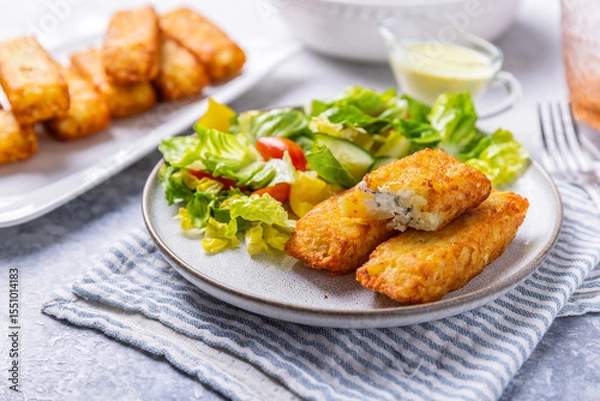 Obraz Fried potato pocked filled with cream cheese and herbs with mixed salad
