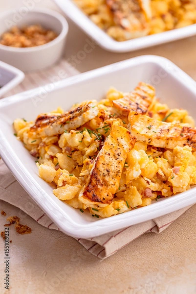 Obraz German egg dumplings with bacon, fried onions and grilled Halloumi cheese