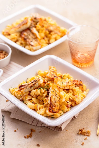 Obraz German egg dumplings with bacon, fried onions and grilled Halloumi cheese