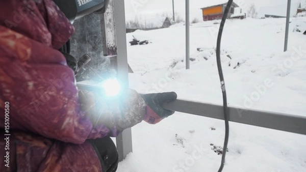 Fototapeta Metalworking in the challenging snowy conditions showcases immense skill and dedication amidst winters chill