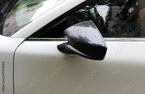 Obraz The rear view mirror is attached to the side surface of the car door after heavy rain