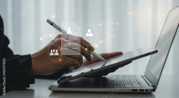 Fototapeta Digital workflow: Hand using stylus on tablet, laptop, and user interface elements, soft focus.
