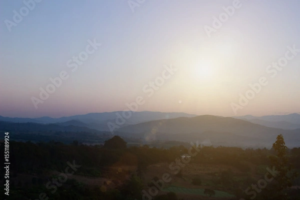 Fototapeta Natural background blurring warm colors and bright sun light. Bokeh or Christmas background Green Energy at sky sunny color orange light patterns plain abstract flare evening clouds blur.