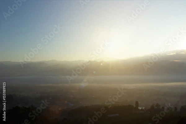 Fototapeta Natural background blurring warm colors and bright sun light. Bokeh or Christmas background Green Energy at sky sunny color orange light patterns plain abstract flare evening clouds blur.