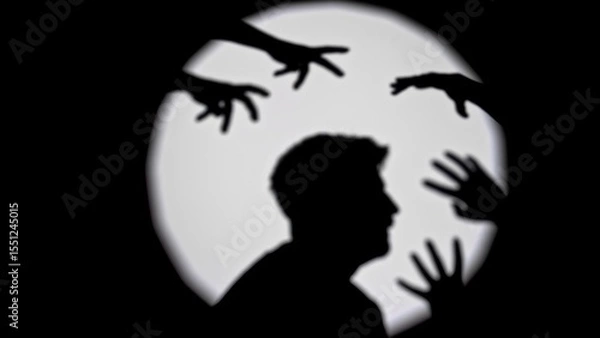 Fototapeta Silhouette of Person Surrounded by Reaching Shadows