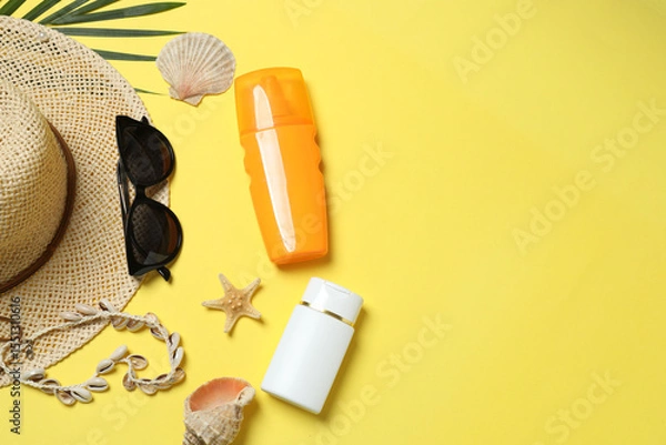 Fototapeta Tropical vibes shot from above. Straw hat, sunglasses, pineapple, wicker bag, beach accessories on yellow background. Perfect for advertising or text overlays