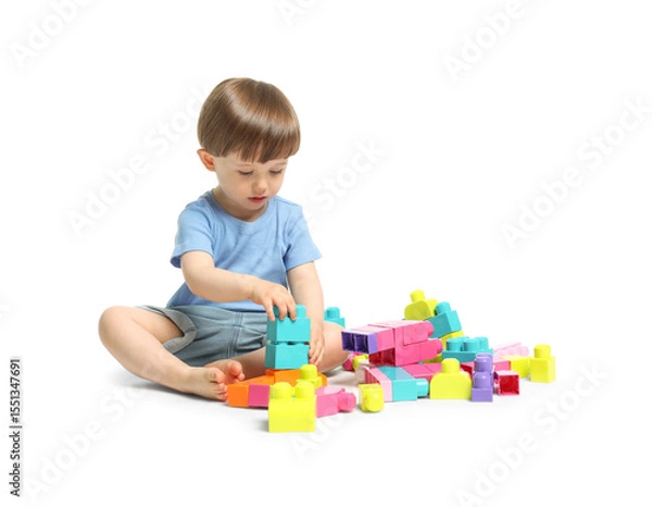 Fototapeta Cute little boy playing with building bricks on white background