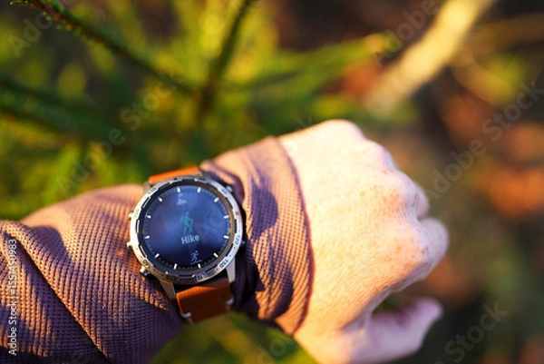 Obraz Hiker with sports watch in Expedition. Adventurer Smartwatch for traveling. Smartwatch with GPS track for Expedition. Watch for Outdoor and Hiking. Traveler with watch on hand in adventure.