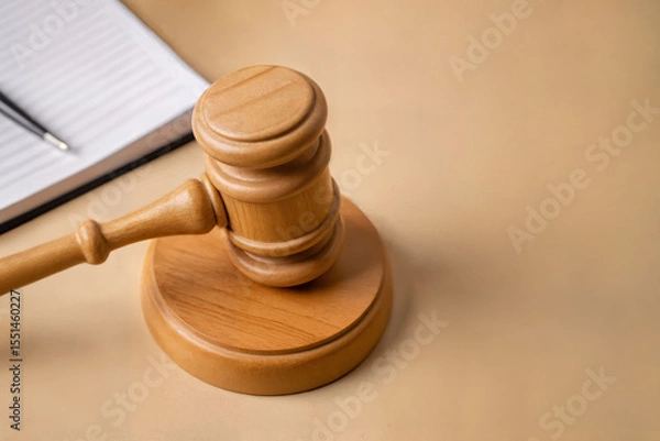 Fototapeta wooden judge gavel and notebook on wooden table, law concept