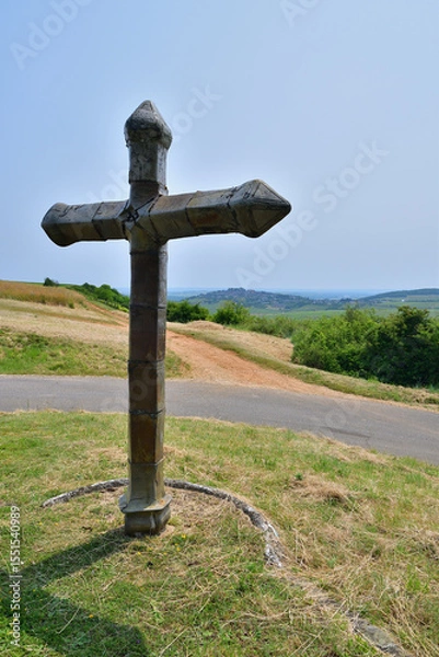 Obraz A cross standing on a hill in Sancerre, France, with a distant view of the town. June 9, 2025.