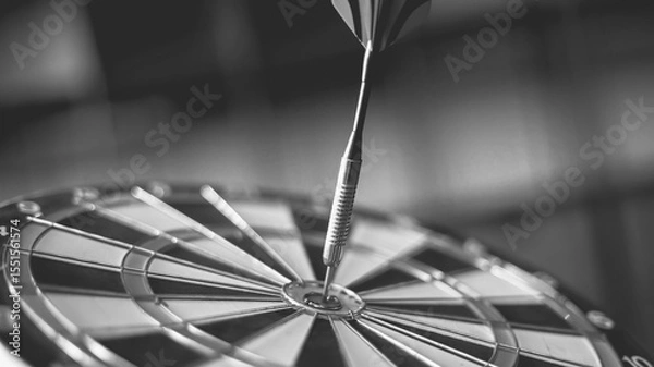Fototapeta Dart arrow hitting in the target center of dartboard
