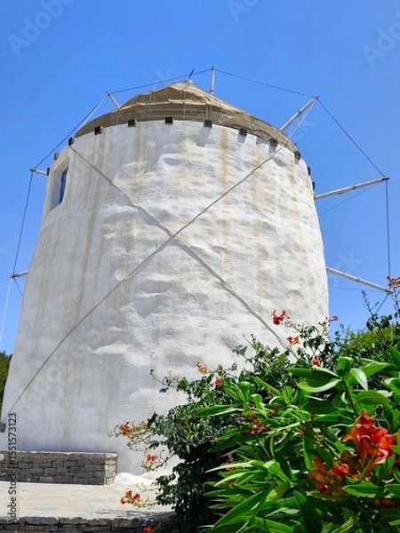 Fototapeta Closeup view of a traditional Cycladic windmill in Parikia on Paros island, Greece - one of many iconic, whitewashed windmills that are a charming symbol of the island’s rich cultural heritage.