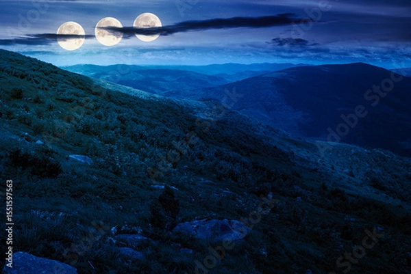 Obraz wonderful mountain landscape for travel with green hill in summer at night. nature scenery with scenic view in to the distant valley in dappled full moon light. hiking through highland. fake news