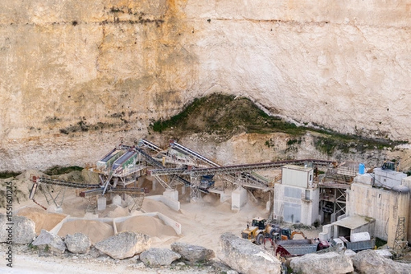 Obraz Limestone Quarry with Industrial Machinery in a Cliffside Setting in Malta