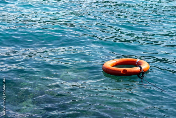 Obraz Lifebuoy floats on the ocean. Security concept.