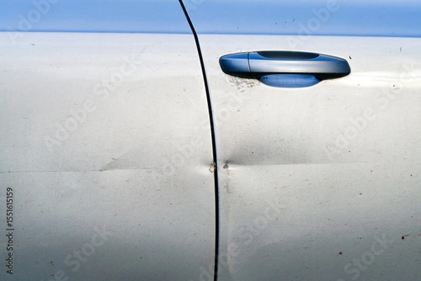Fototapeta Front and rear car doors with visible scratches, dents, and paint damage caused by minor collision or parking impact. Scratched, dented paintwork on car doors, body damage with visible dents, scrapes