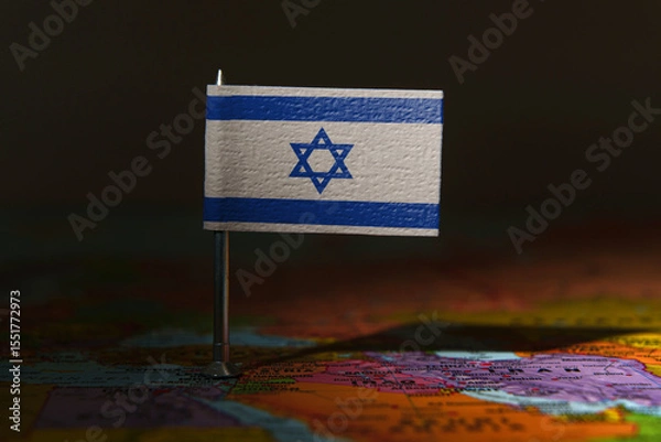 Fototapeta Israel flag pin placed on a map, symbolizing location, politics, or national identity.