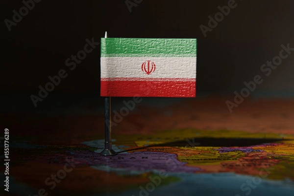 Fototapeta Iran flag pin placed on a map, symbolizing location, politics, or national identity.