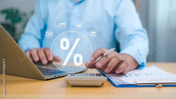 Obraz Businessman using laptop and calculator to manage finance, tax rates, banking interest, accounting, investments. Financial data analysis and interest rate percentage representing economic strategy.