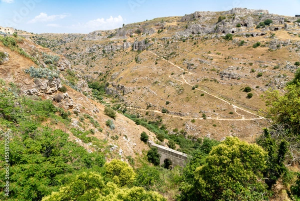 Fototapeta View across canyon landscape with trails and caves