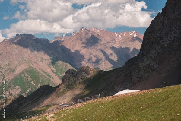 Obraz A beautiful mountain landscape of the peaks of the Zailiysky Alatau opens up from the popular tourist Talgar Pass in the city of Almaty