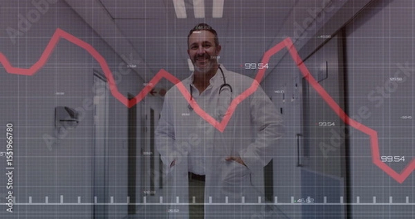 Obraz Standing doctor wearing white lab coat and stethoscope in hospital corridor, with red chart overlay