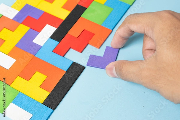 Obraz geometric shape block with colorful wood puzzle piece background. logical thinking, business logic, Conundrum, decision, solutions, rational, mission, success, goals and strategy concepts