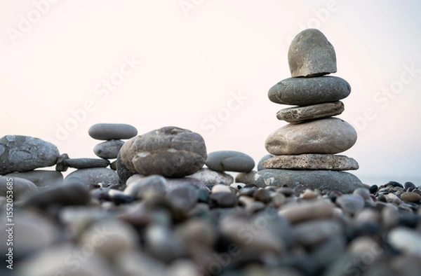 Obraz Stacked stones on a pebbled beach creating a tranquil and balanced natural scene