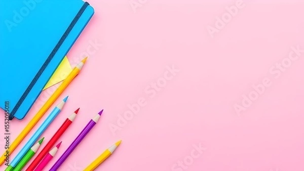 Fototapeta Colorful pencils and blue notebook on pink background - bright flat lay composition of school art supplies for creative education concept