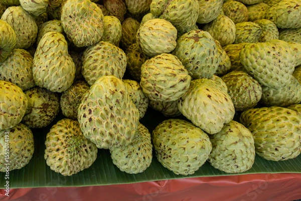 Obraz custard apple piled up on banana leaves
