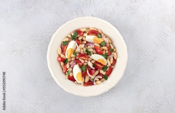 Fototapeta High protein salad with eggs, beans, cherry tomatoes, onions on a white background. Piaz salad.