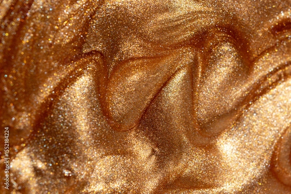 Fototapeta Glowing golden shimmering cosmetic texture of gel or body spray. Background texture for backdrops or mapping.