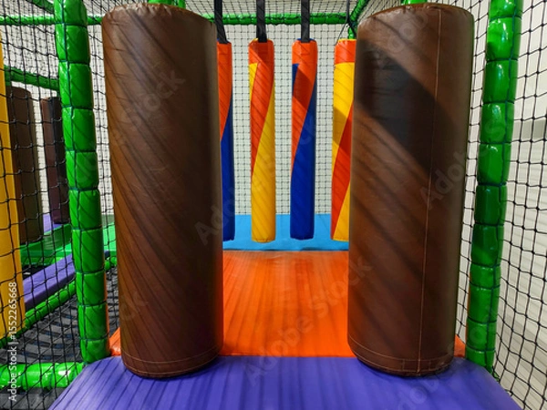 Fototapeta Colorful Multicoloured Vibrant Indoor Soft Obstacle Jungle Gym Course At A Kids Playground Without Logos Or Trademarks.